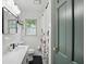 Modern bathroom featuring a sleek vanity, stylish fixtures, and a tiled shower area at 6102 Primrose Ave, Indianapolis, IN 46220