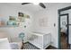 Well-lit Bedroom with a white crib, soft chair, and cute animal prints on the wall at 6102 Primrose Ave, Indianapolis, IN 46220