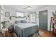 Serene bedroom with a king-sized bed, decorative headboard, and natural light from the window at 6102 Primrose Ave, Indianapolis, IN 46220