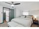 Bright bedroom boasts a king-sized bed, complemented by a cozy bench and a charming bedside table with lamp at 6102 Primrose Ave, Indianapolis, IN 46220