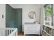 Charming Bedroom with a white dresser, round mirror, and a view to the outside at 6102 Primrose Ave, Indianapolis, IN 46220