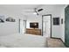 A beautifully designed bedroom features modern ceiling fan, dresser, and doorway leading to the ensuite bathroom at 6102 Primrose Ave, Indianapolis, IN 46220