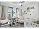 Cozy Bedroom featuring a white crib, comfortable chair, and shelves filled with colorful books at 6102 Primrose Ave, Indianapolis, IN 46220