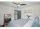 Comfortable bedroom with a queen bed, ceiling fan, and view from the bed at 6102 Primrose Ave, Indianapolis, IN 46220