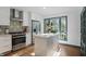 Modern kitchen with stainless steel appliances, a center island, and white cabinetry at 6102 Primrose Ave, Indianapolis, IN 46220