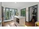 Kitchen island with microwave and breakfast bar, complemented by natural light from the surrounding windows at 6102 Primrose Ave, Indianapolis, IN 46220