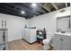 Finished laundry room with modern washer/dryer, shelving, and updated vanity at 6102 Primrose Ave, Indianapolis, IN 46220