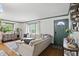 Bright living room with hardwood floors, large sofa, stylish decor, and plenty of natural light at 6102 Primrose Ave, Indianapolis, IN 46220