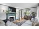Bright living room featuring a decorative fireplace, hardwood floors, stylish decor, and comfortable seating at 6102 Primrose Ave, Indianapolis, IN 46220