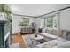Well-lit living room with hardwood floors, a decorative fireplace, and a cozy sectional sofa at 6102 Primrose Ave, Indianapolis, IN 46220