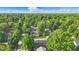 The aerial shot captures a tree lined neighborhood, offering a scenic place to live at 6102 Primrose Ave, Indianapolis, IN 46220