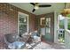 Cozy front porch with wicker chairs, a small table, hanging flowers, and a view to the interior at 6102 Primrose Ave, Indianapolis, IN 46220