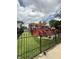 Expansive backyard with a spacious deck, pergola and black metal fence at 6126 Regina Cir, Indianapolis, IN 46224