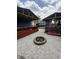 Backyard featuring fire pit, covered outdoor kitchen, and patio at 6126 Regina Cir, Indianapolis, IN 46224