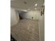 Finished basement with tile floors, recessed lighting, and two entry doors at 6126 Regina Cir, Indianapolis, IN 46224