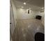 Finished basement with wood-look tile floors and an electric fireplace at 6126 Regina Cir, Indianapolis, IN 46224