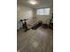 Bright exercise room features workout equipment and wood-look flooring at 6126 Regina Cir, Indianapolis, IN 46224