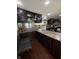 Spacious kitchen with wood cabinets, tile countertops, breakfast bar, and stainless steel appliances at 6126 Regina Cir, Indianapolis, IN 46224
