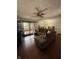 Comfortable living room with hardwood floors, a ceiling fan, and natural light at 6126 Regina Cir, Indianapolis, IN 46224