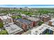 An aerial view of residential buildings with green rooftops, trees and a cityscape in the background at 630 N College Ave # 105, Indianapolis, IN 46204