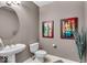 This bathroom features a stylish pedestal sink, contemporary decor, and neutral wall tones at 630 N College Ave # 105, Indianapolis, IN 46204