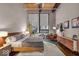 Inviting bedroom features a queen-sized bed, brick accent wall, and stylish decor at 630 N College Ave # 105, Indianapolis, IN 46204
