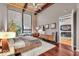 Spacious bedroom features a queen sized bed, exposed beams, and bright light at 630 N College Ave # 105, Indianapolis, IN 46204