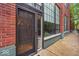 Stylish entrance with large windows and a modern brick facade exudes urban charm and elegance at 630 N College Ave # 105, Indianapolis, IN 46204