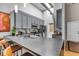 Modern kitchen featuring gray cabinets, stainless steel appliances, and a large island with bar seating at 630 N College Ave # 105, Indianapolis, IN 46204