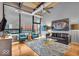Bright living room with large windows, hardwood floors, and a chic black and white rug at 630 N College Ave # 105, Indianapolis, IN 46204