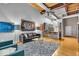 Open-concept living room with modern decor, including a comfortable sofa, armchairs, and stylish rug at 630 N College Ave # 105, Indianapolis, IN 46204