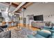 Spacious living room with hardwood floors, exposed ceilings, and an open layout at 630 N College Ave # 105, Indianapolis, IN 46204