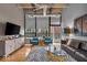 Cozy living room with exposed ceilings, hardwood floors, and stylish, modern furniture at 630 N College Ave # 105, Indianapolis, IN 46204