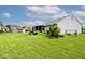 Beautiful backyard with a screened porch, well-kept lawn, mature landscaping, and a storage shed, offering outdoor comfort at 6406 Longhorn Ct, Indianapolis, IN 46237