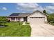Inviting single-story home featuring a well-maintained lawn, solar panels, and attached two-car garage at 6406 Longhorn Ct, Indianapolis, IN 46237