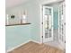 Light-filled room with wood floors leading to another room with French doors at 6406 Longhorn Ct, Indianapolis, IN 46237