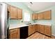 Spacious kitchen with wooden cabinets, stainless steel refrigerator and modern appliances at 6406 Longhorn Ct, Indianapolis, IN 46237