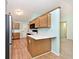 Kitchen view of wooden cabinets, white countertops, stainless steel appliances, and hardwood flooring at 6406 Longhorn Ct, Indianapolis, IN 46237