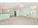 Open living room with neutral carpet and a view of the adjacent kitchen at 6406 Longhorn Ct, Indianapolis, IN 46237