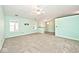 Spacious living room with neutral carpet, complemented by natural light from adjacent dining area at 6406 Longhorn Ct, Indianapolis, IN 46237