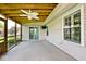 A covered porch features a wood ceiling with fan and ample space for entertaining and relaxing at 6406 Longhorn Ct, Indianapolis, IN 46237