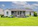 Charming screened porch with a well-manicured lawn, surrounded by vibrant plants and providing a tranquil outdoor living area at 6406 Longhorn Ct, Indianapolis, IN 46237