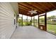 Enjoy serene views from the screened porch with a wood beam ceiling, fan, and view of the pond at 6406 Longhorn Ct, Indianapolis, IN 46237
