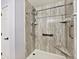 Renovated shower stall with brown marbled walls and built-in seating at 6406 Longhorn Ct, Indianapolis, IN 46237