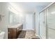 Bathroom featuring a shower with glass doors, gray walls, and a vanity with a dark wood finish at 6579 Aster Dr, Pendleton, IN 46064