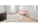 Cozy bedroom with a pink love seat, white beanbag chair, and stylish geometric rug at 6579 Aster Dr, Pendleton, IN 46064