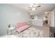 Bright bedroom features plush pink seating, neutral walls, and eye-catching geometric rug at 6579 Aster Dr, Pendleton, IN 46064