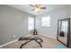 Home exercise room with bench, weights, mirror, and plenty of natural light at 6579 Aster Dr, Pendleton, IN 46064