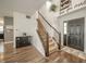 Foyer with hardwood floors, staircase, and modern decor, leading to the main living areas at 6579 Aster Dr, Pendleton, IN 46064