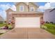 Two-car garage with beautiful landscaping and flower boxes on an inviting home exterior at 6579 Aster Dr, Pendleton, IN 46064